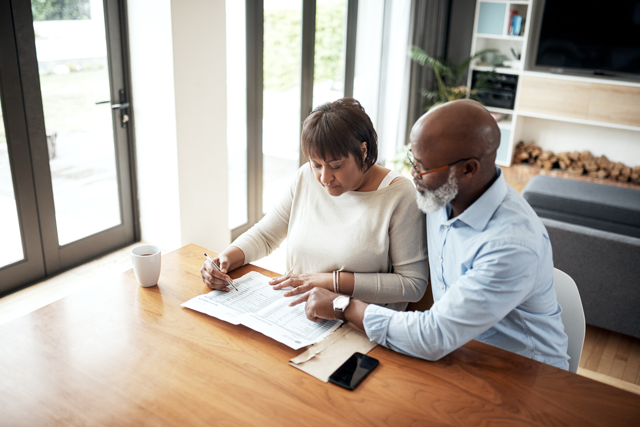 couple looking over a 401k; retirement plan. Rolling over a 401k