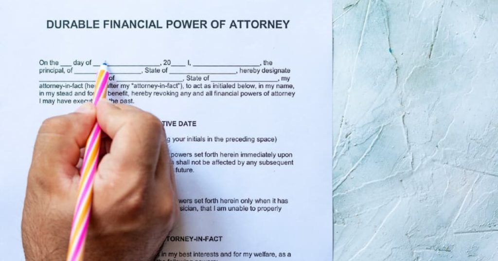 Person filling out a durable financial power of attorney form.