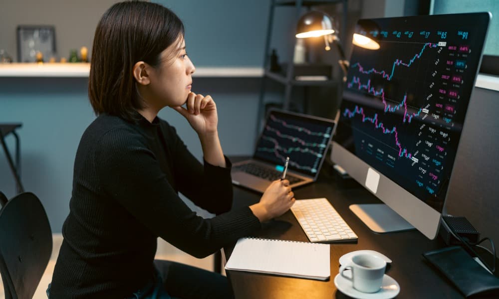 Woman at a computer considering safe investments