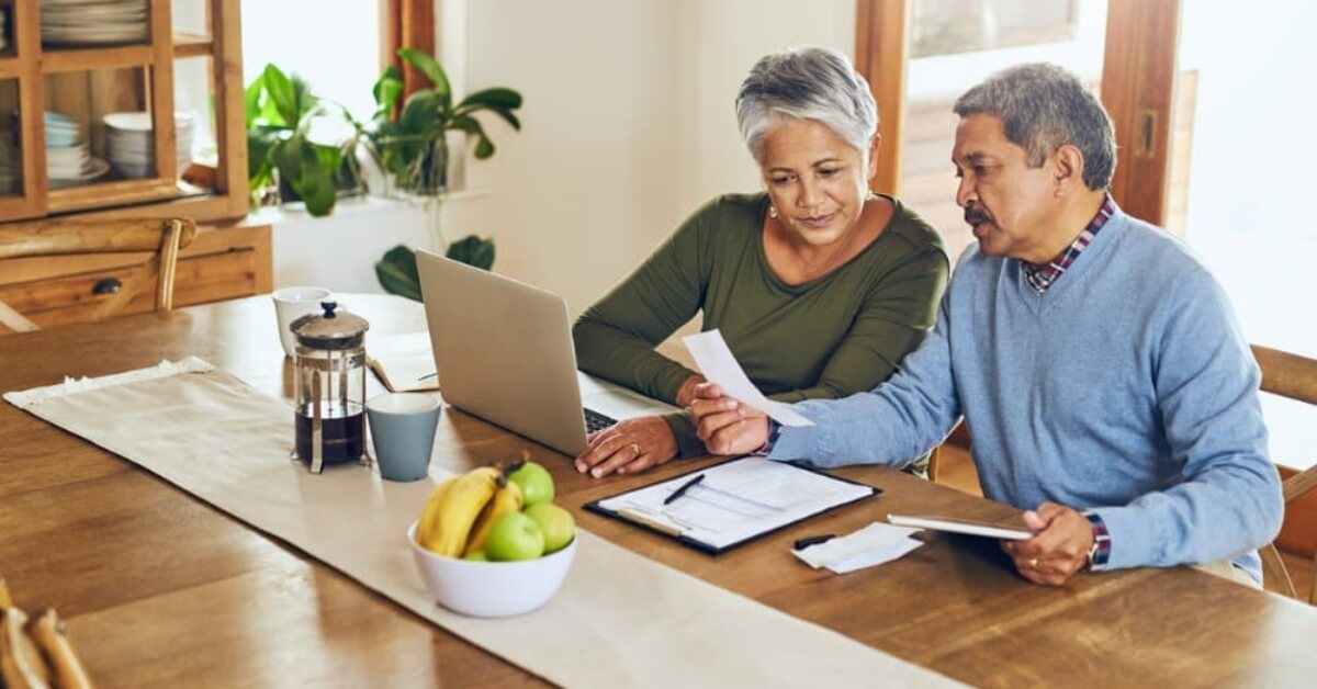A couple at a table considering the pros and cons of a tax-free retirement account