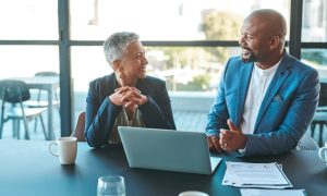 Fiduciary advisors discussing finances with their client’s best interest in mind