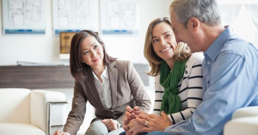 Couple meeting with a financial professional to discuss financial planning and advice.