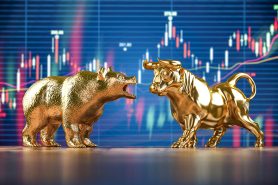 Golden bull and bear on stock data chart background. Investing,